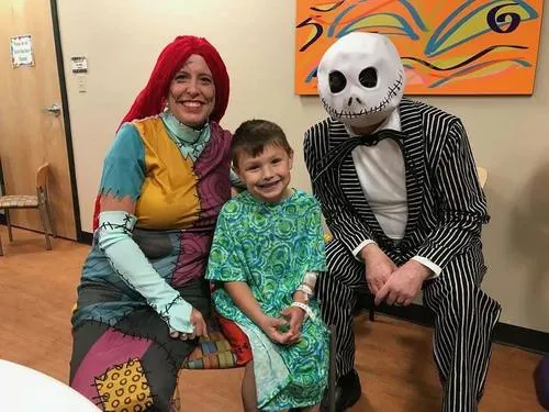 HappyFeet Slippers characters with a patient at Norton Children's Hospital